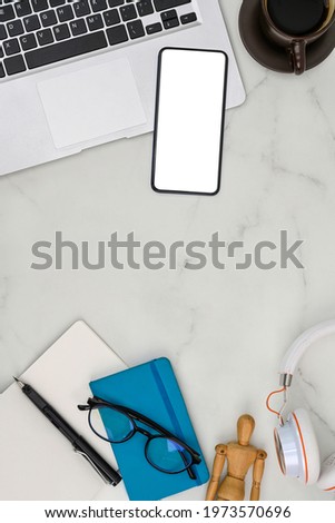 Mock up mobile phone, laptop, notebook and coffee cup on marble background.