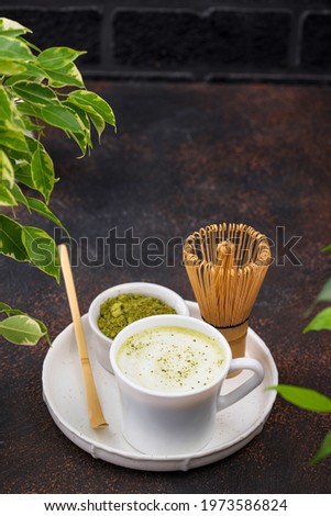 Green healthy matcha latte drink and bamboo tools for prepared