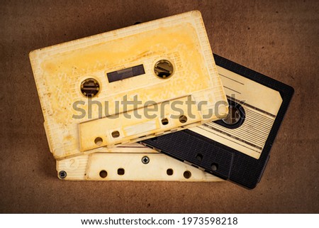 Toned Photo of the Three Old Audio Cassettes on the Cardboard Background closeup
