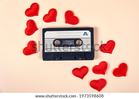 Old Audio Cassette with a Red Hearts on the Paper Background closeup