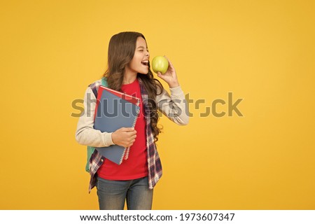 Clever eating. Little kid eat apple yellow background. School break. Fruit snack. Brain food. Cognitive health. Diet and dieting. Every girl should be eating healthy food, copy space