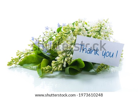 bouquet of white lilacs with a thank you card on a white background