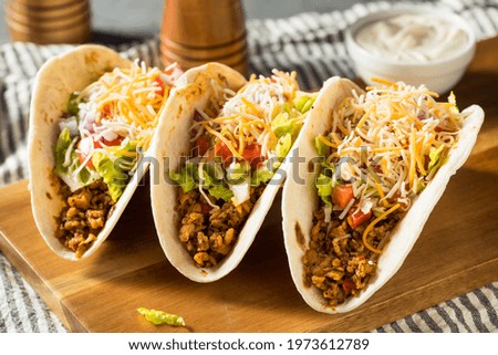 Homemade American Soft Shell Beef Tacos with Lettuce Tomato Cheese Royalty-Free Stock Photo #1973612789