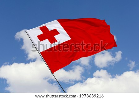 Tonga flag isolated on sky background with clipping path. close up waving flag of Tonga. flag symbols of Tonga.