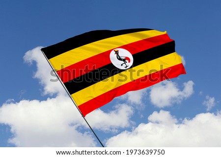 Uganda flag isolated on sky background with clipping path. close up waving flag of Uganda. flag symbols of Uganda.