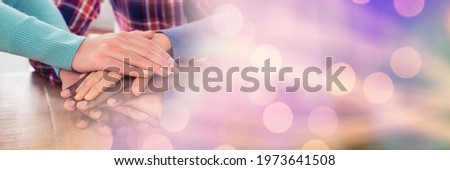Composition of midsection of people stacking hands with spots of light. friendship, motivation and teamwork concept digitally generated image.