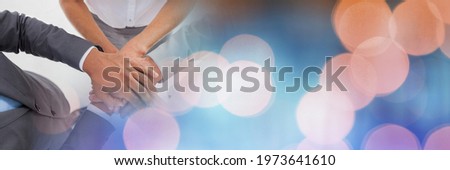 Composition of midsection of business people stacking hands with spots of light. business, motivation and teamwork concept digitally generated image.