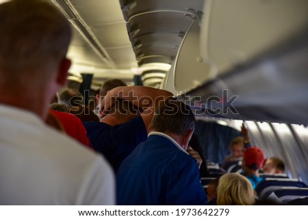 People go to the evacuation exit on the plane. Royalty-Free Stock Photo #1973642279