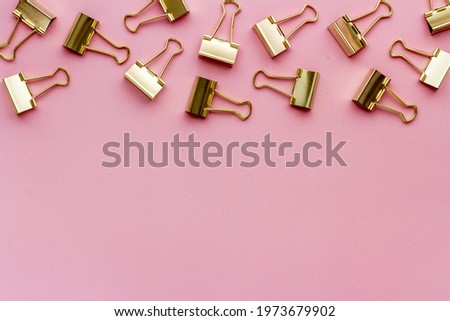Paper binder clips. Stationery and office supplies background.