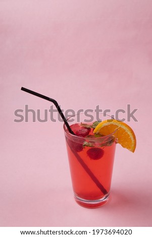 on the table, soft drinks, various cocktails, a glass with a straw and a slice of lemon, a blurred background