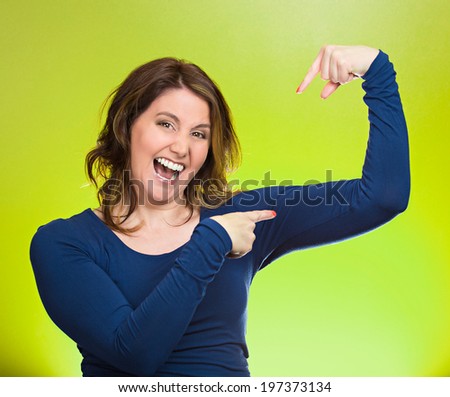 Closeup portrait beautiful, pretty model woman flexing muscles showing, displaying her strength, isolated green background. Positive human emotions, facial expressions, feelings, attitude, perception