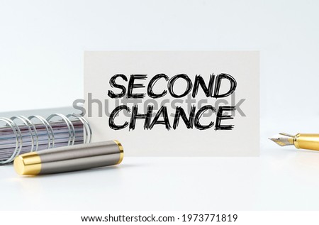 Business and finance concept. On the table is a notebook, a pen and a business card with the inscription - Second chance