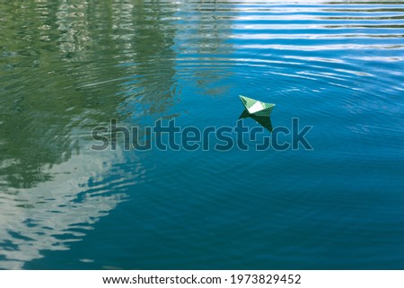 White paper skiffs float on water