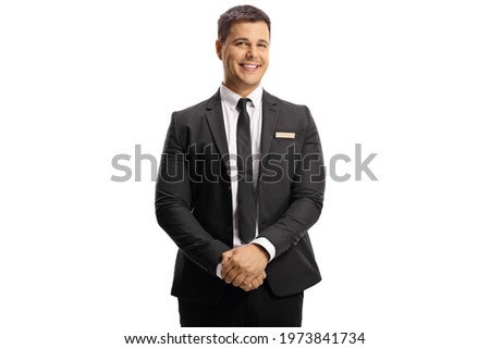 Young elegant man with a name tag on his suit smiling at camera isolated on white background