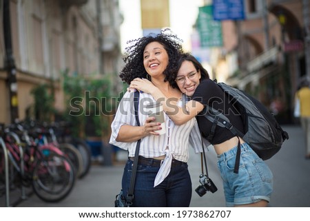  Two tourist women on street.  I love you my friend. 