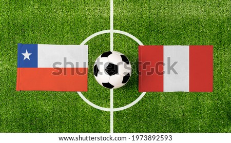 Top view soccer ball with Chile vs. Peru flags match on green football field.