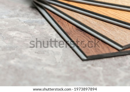 Sample stack of vinyl sheet wood pattern on composition space for interior design works Royalty-Free Stock Photo #1973897894
