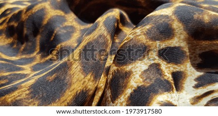 Translucent fabric, with leopard print, in folds (texture).
