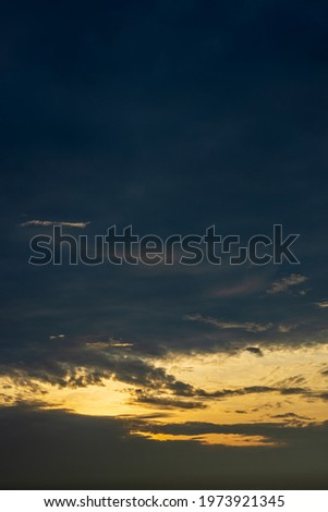 Cloudy scenery background in the blue sky with orange yellow sunlight in the early morning space.
