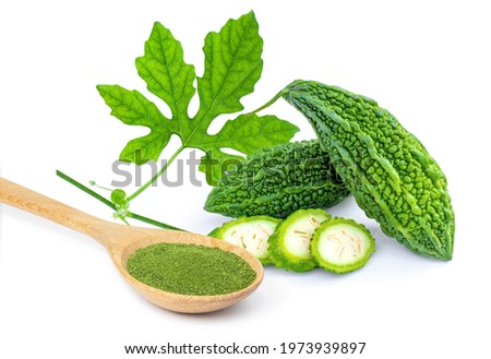 Bitter gourd or bitter melon with green herbal powder in wooden spoon isolated on white background.  Royalty-Free Stock Photo #1973939897