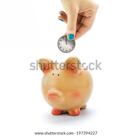 Hand depositing coin with clock dial in piggy bank