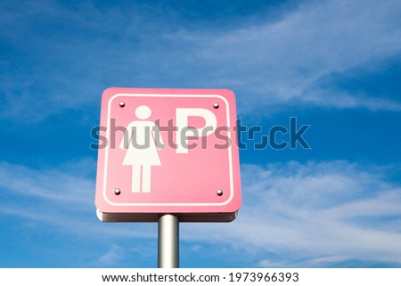 Pink ladies sign mark of car parking on sky background.