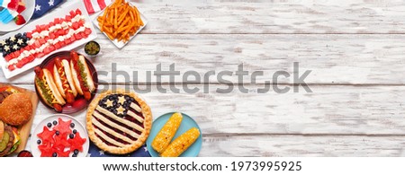 Fourth of July, patriotic, American themed food. Above view corner border on a white wood banner background. Copy space.