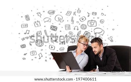 Young businessman and businesswoman with all kind of hand-drawn icons in background