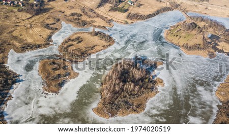 Aerial view of frozen water reservoir with islands, Aizpute, Latvia.