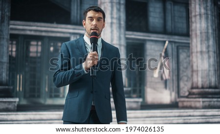 Anchorman Reporting Breaking News Live Outside an United States of America Parliament, Court or Other Government Building with Columns. Newsreader Delivers Journalistic Program on Television. Royalty-Free Stock Photo #1974026135