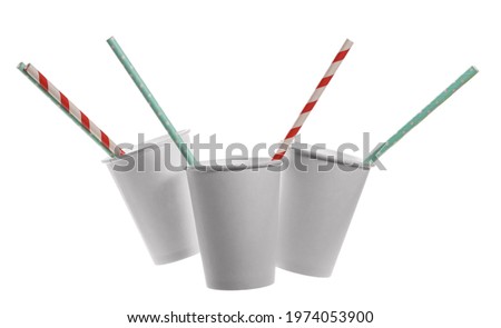 Empty white paper cup with colorful straw isolated on background, clipping path