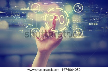 PPC - Pay per click concept with a hand pressing a button at night Royalty-Free Stock Photo #1974064052