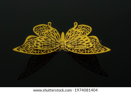 gold metal butterflies on black background