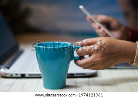 Woman holding coffee cup. Ready notebook. In doing business online. Ways to earn money while at home