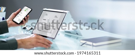 Accountant Checking Online Invoice On Tablet Screen Royalty-Free Stock Photo #1974165311