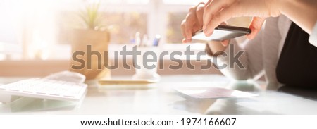 Remote Payroll Cheque Deposit Taking Picture Using Phone Royalty-Free Stock Photo #1974166607