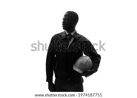 Silhouette of standing black engineer.