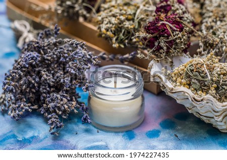 Bunches of grass, aromatic salt, aromatic candle. Home decor, cleaning, spa treatments photo.