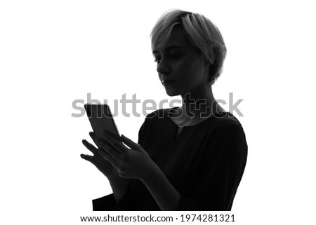 Silhouette of caucasian woman using a smart phone. Royalty-Free Stock Photo #1974281321