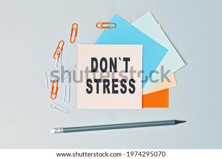 DonT Stress - text on sticky note paper on gray background. Closeup of a personal agenda. Top view. Conceptual photo