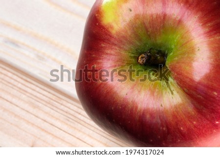 Fruit picture red ripe sweet apple on a light wooden background close-up macro photography