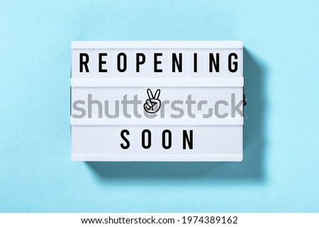 Reopening soon. Light box with text on blue background
