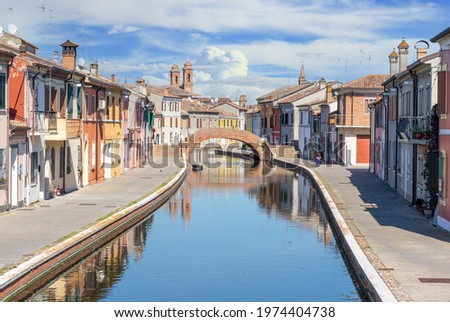 Comacchio, Italy - often compared to Venice for the canals and the architecture, Comacchio displays one of the most characteristic old towns in Emilia Romagna Royalty-Free Stock Photo #1974404738