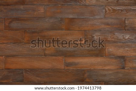 Dark brown textured wooden background made from horizontal planks with knots and grain.