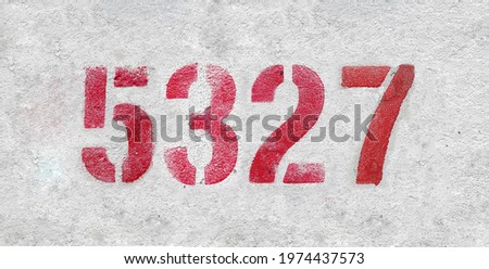 Red Number 5327 on the white wall. Spray paint.