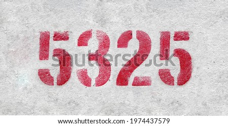 Red Number 5325 on the white wall. Spray paint.