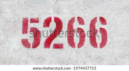 Red Number 5266 on the white wall. Spray paint.