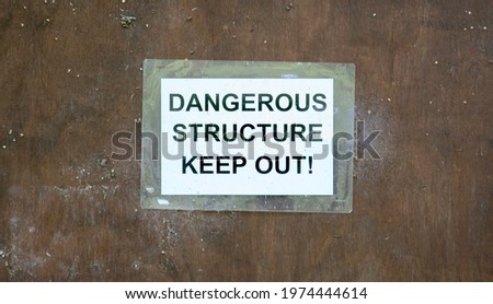 An old sign to identify a dangerous structure and insisting that people keep out