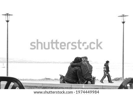 couple in love on the bench in the lake, black and white photo