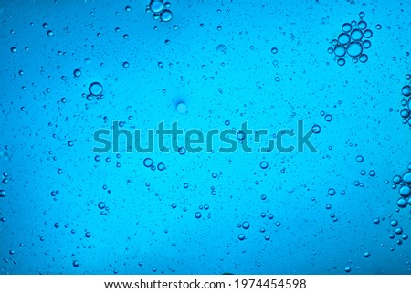 close-up view of a light blue liquid background of moving bubbles
